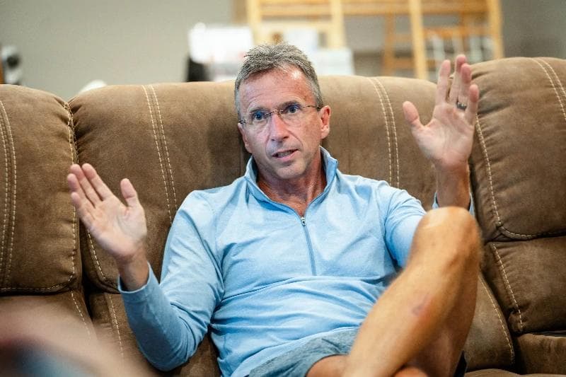Photo of Dean Francis being interviewed in his house